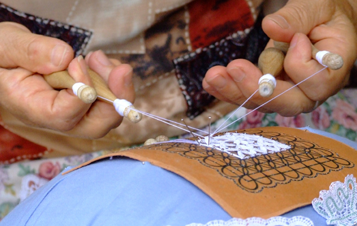 Cheery women crafting the tombolo